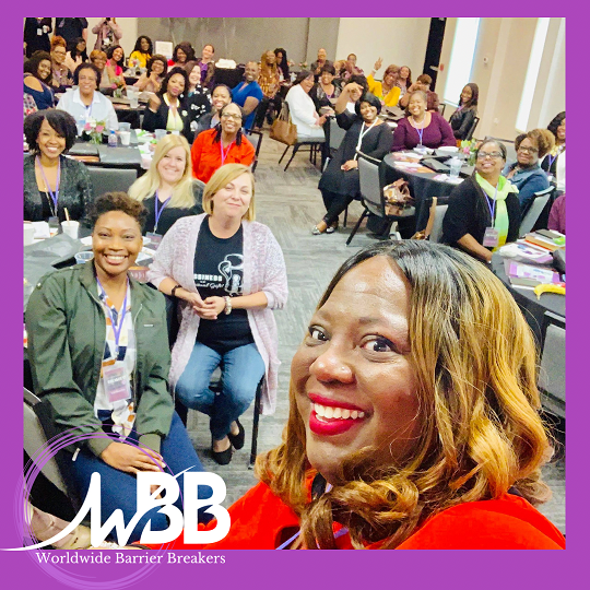 Group of women smiling during conference session.