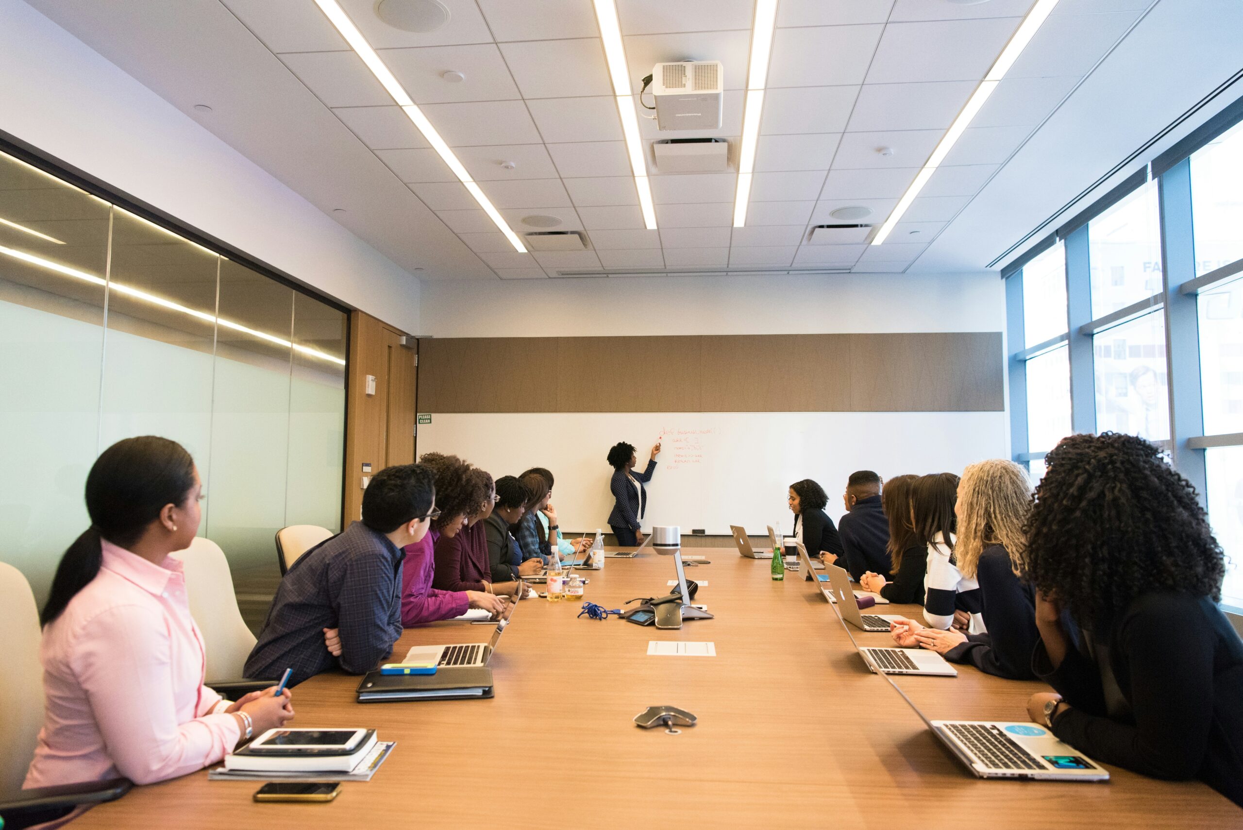 group of people at a conference table watching a presenter