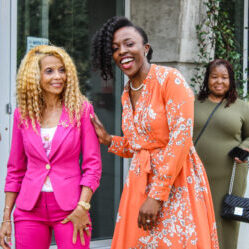 Women standing outside in bright colored clothing