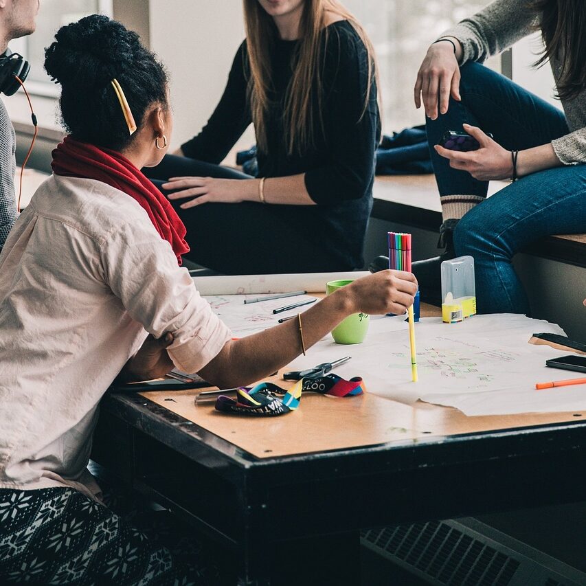 people sitting at a table in a meeting