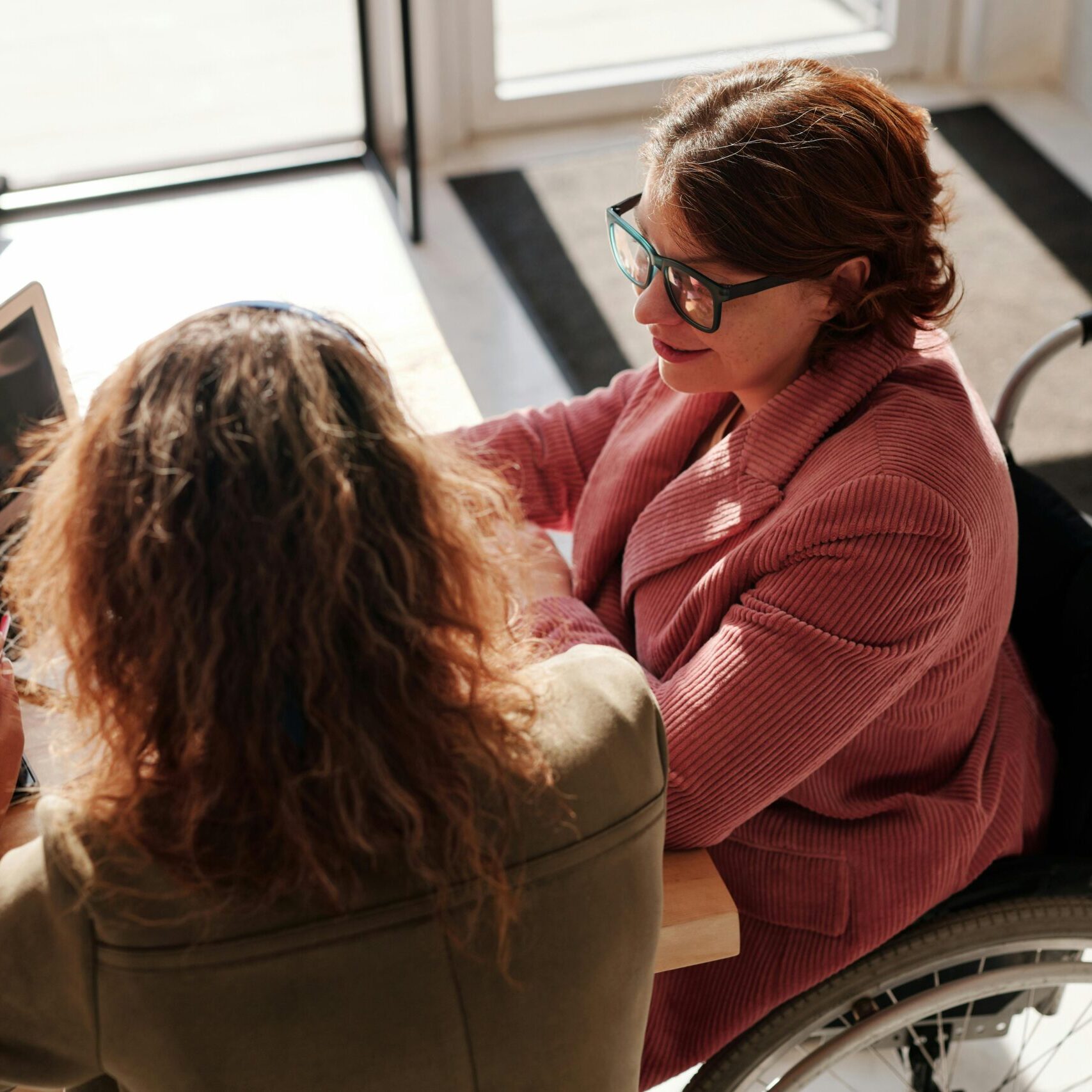 Two people working together around a laptop